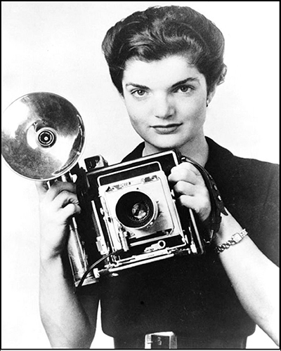 Jacqueline Bouvier with a Speed Graphic Press Camera circa 1952.